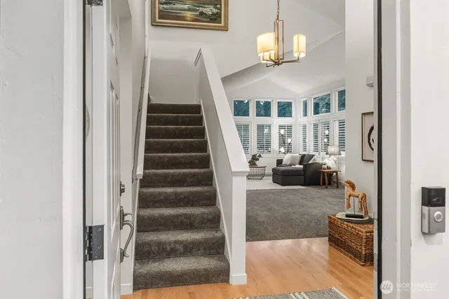 a view of entryway and hall with wooden floor