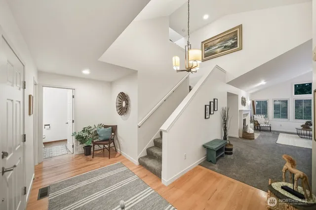 a view of entryway and hall with wooden floor