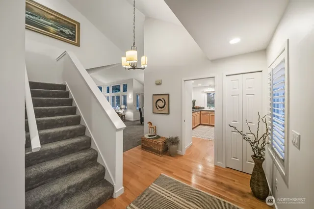 a view of a hallway with wooden floor and staircase