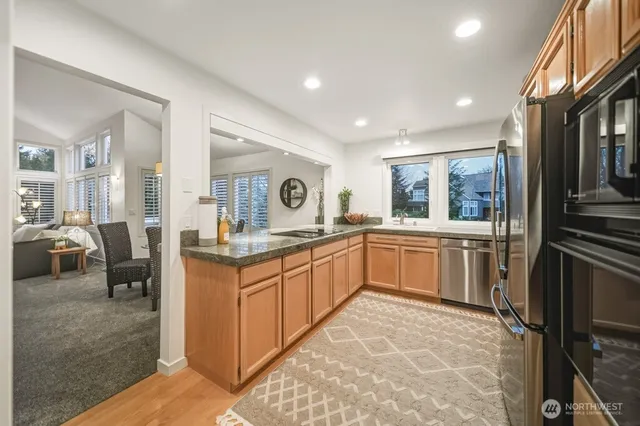 a large kitchen with a sink and cabinets