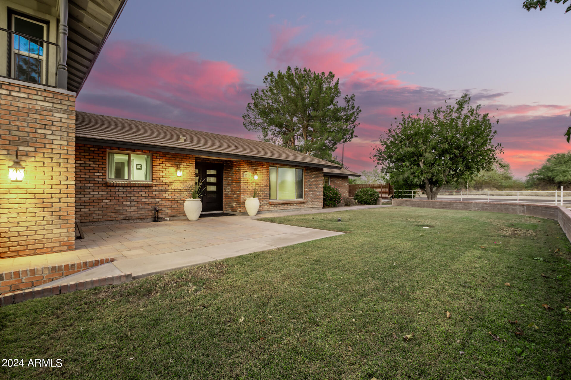 2386 East Redfield Road Gilbert, AZ 85234 - Photo 2 of 107 a front view of a house with a yard and garage