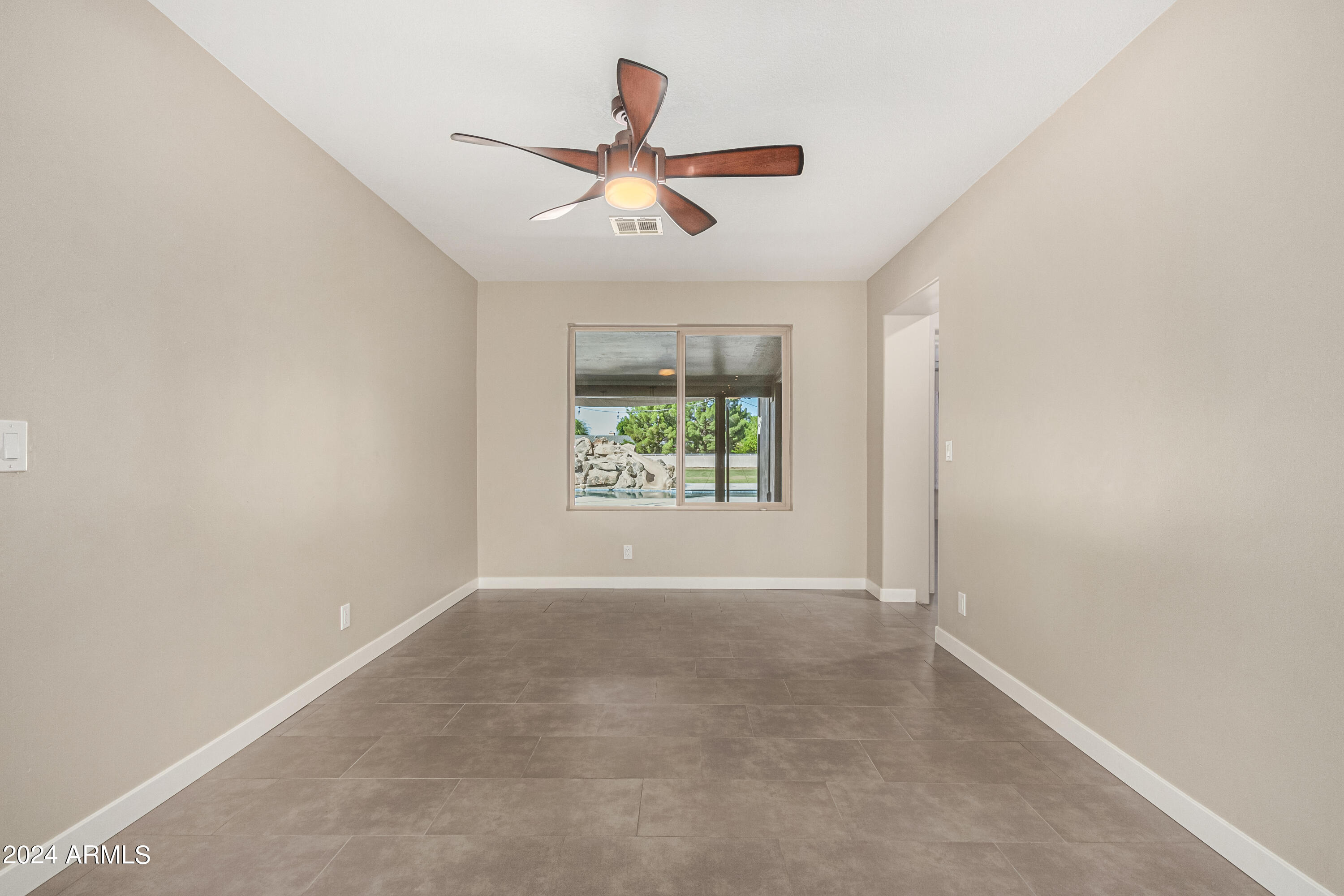 2386 East Redfield Road Gilbert, AZ 85234 - Photo 20 of 107 an empty room with windows and ceiling fan