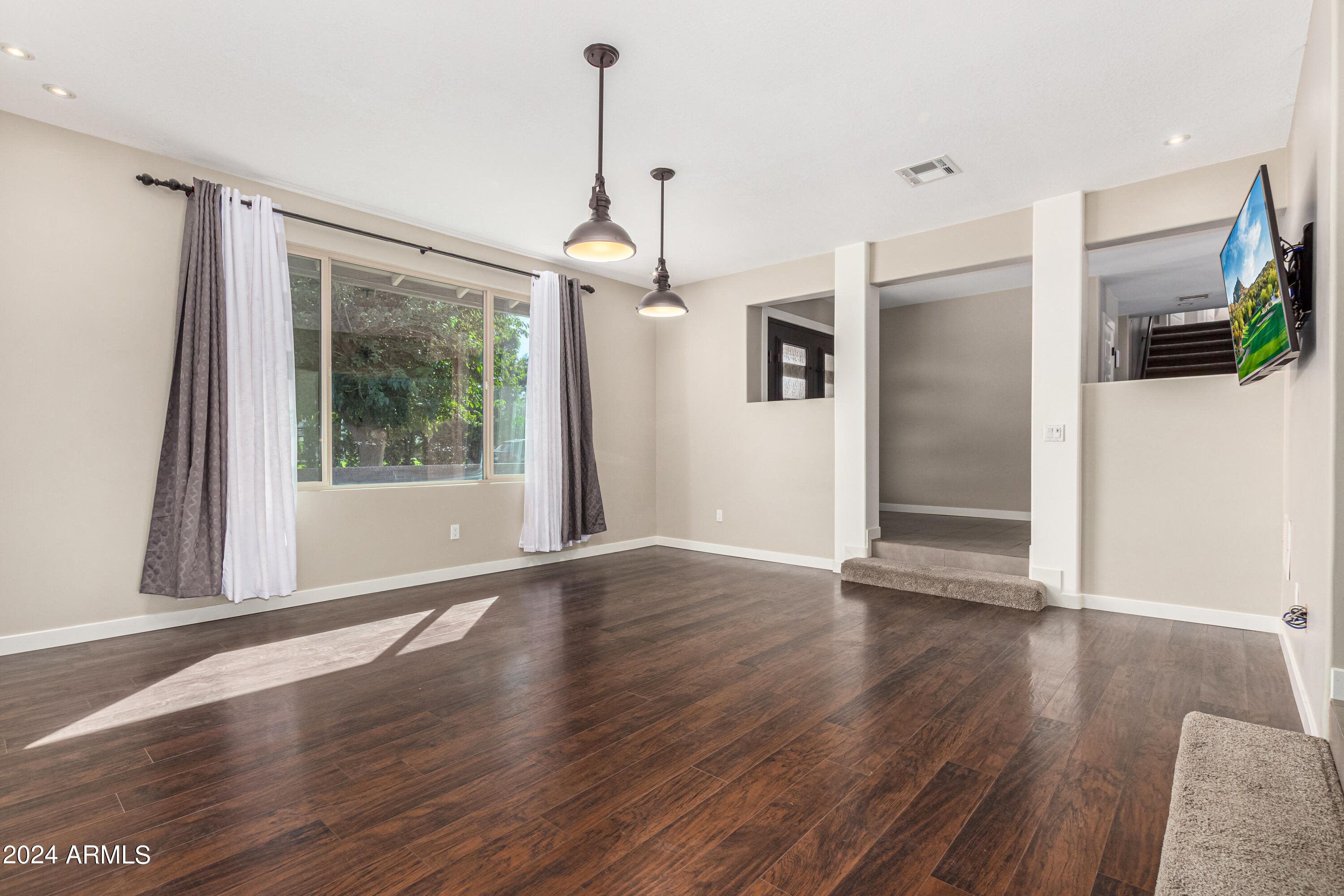 2386 East Redfield Road Gilbert, AZ 85234 - Photo 21 of 107 a view of empty room with wooden floor and fan