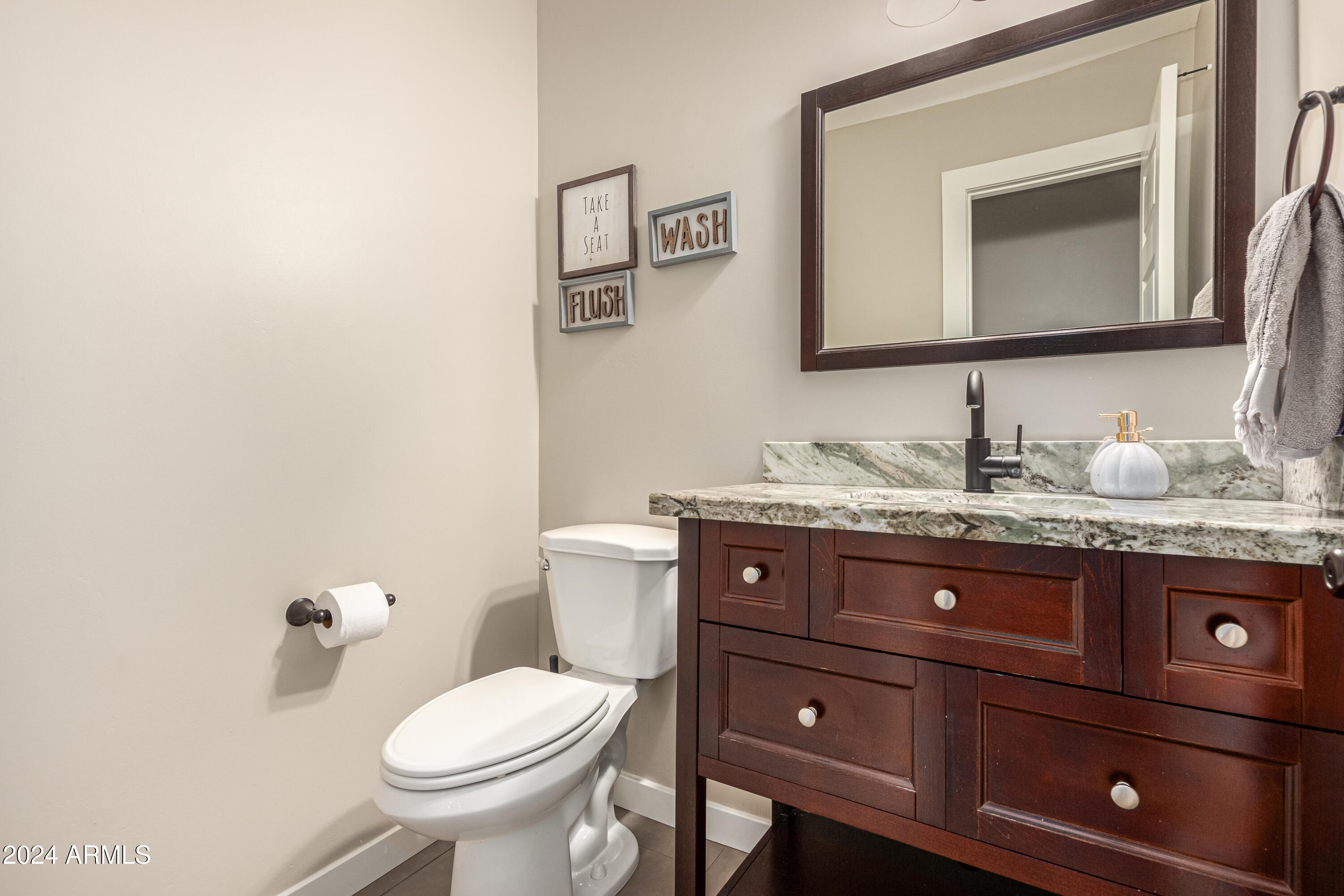 2386 East Redfield Road Gilbert, AZ 85234 - Photo 23 of 107 a bathroom with a toilet sink and mirror