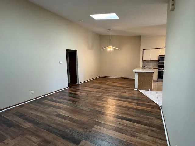a view of a kitchen with a sink and a refrigerator