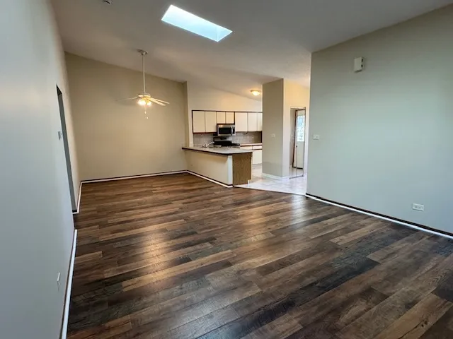 a view of a refrigerator in kitchen and wooden floor