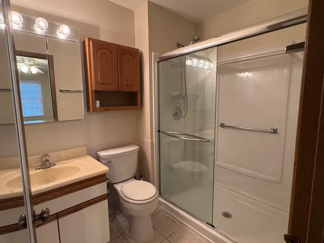 a bathroom with a shower a toilet and a sink