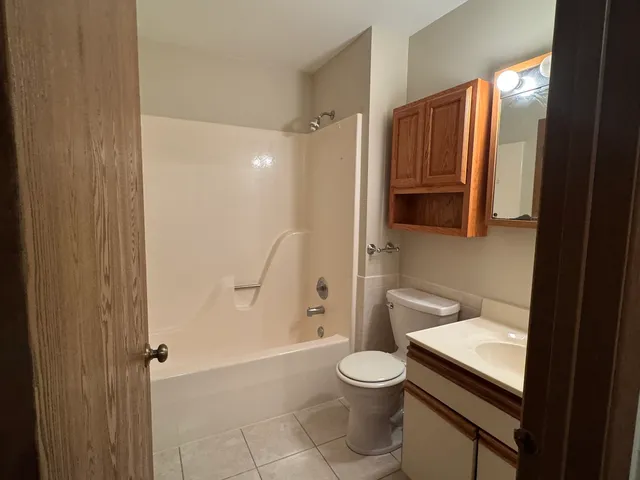 a bathroom with a toilet sink and shower