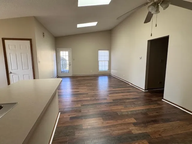 a view of a hallway with wooden floor