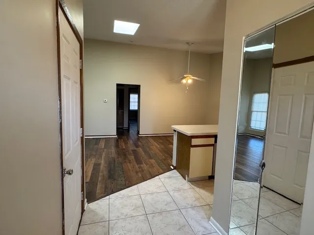 a view of a hallway and wooden floor with a sink