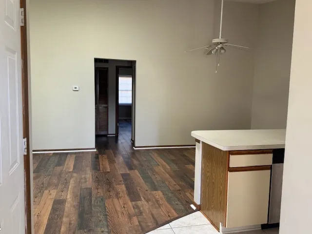 a view of an empty room with closet and a window