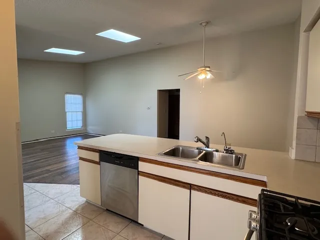 a kitchen with a sink and a mirror