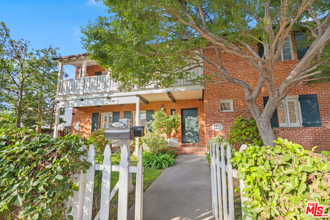 8467 West 4th Street Los Angeles, CA 90048 - Photo 11 of 12 a front view of a house with a garden