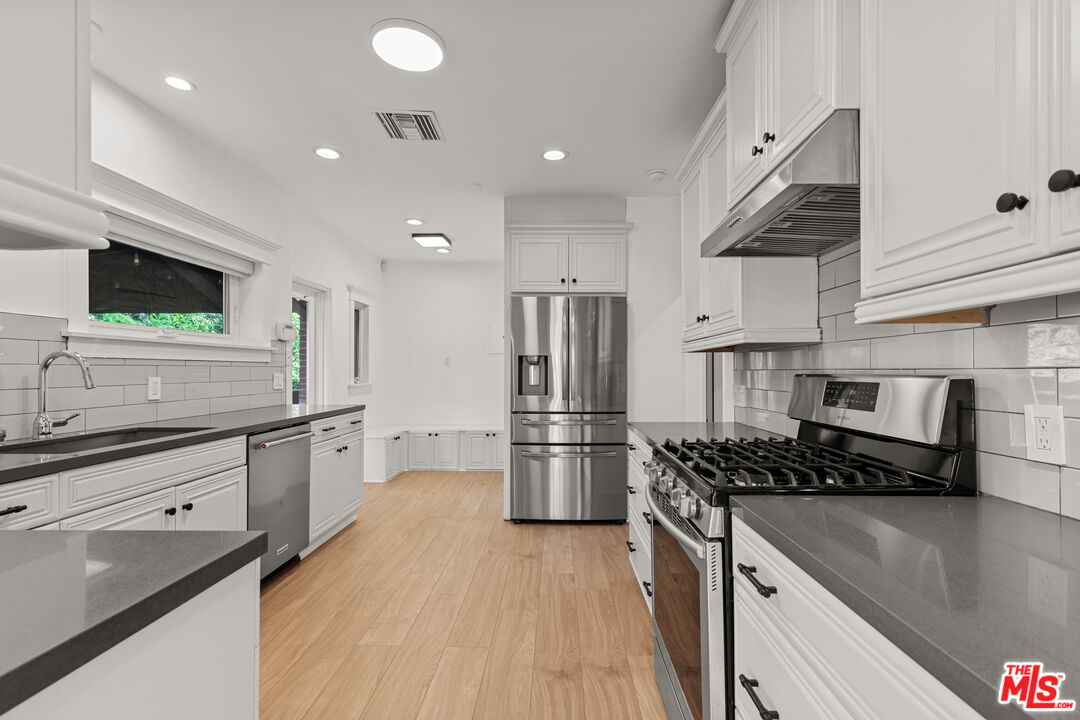 8467 West 4th Street Los Angeles, CA 90048 - Photo 3 of 12 a kitchen with refrigerator and stove