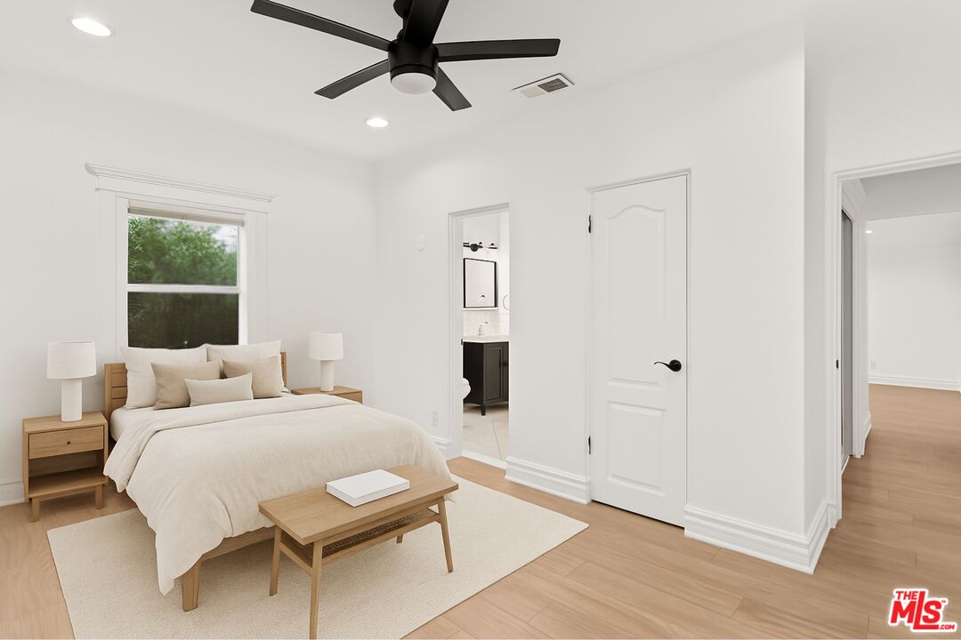 8467 West 4th Street Los Angeles, CA 90048 - Photo 6 of 12 a bedroom with a bed and wooden floor
