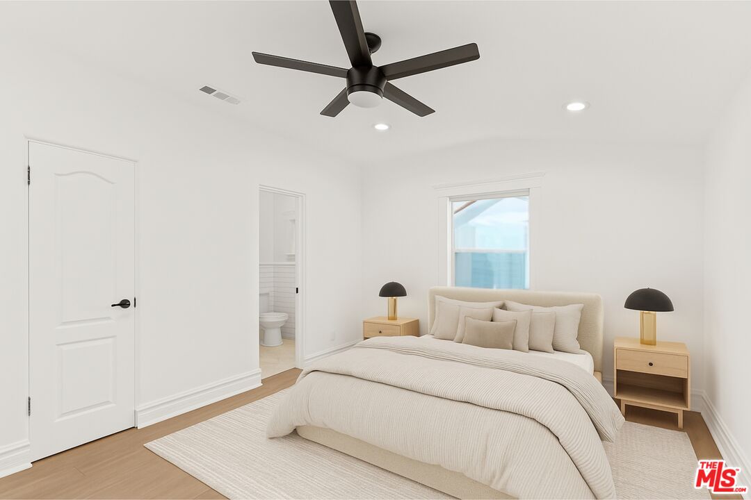 8467 West 4th Street Los Angeles, CA 90048 - Photo 8 of 12 a bedroom with a bed and a ceiling fan