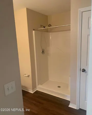 a bathroom with a glass shower door