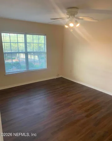 wooden floor in an empty room with a window