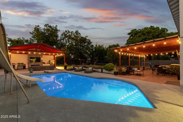 a view of swimming pool with outdoor seating and city view