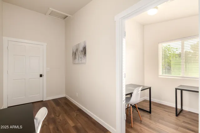 a living room with furniture flat screen tv and wooden floor
