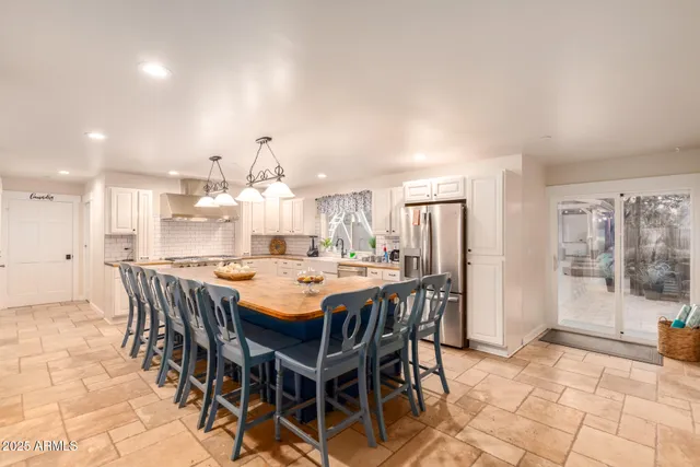 a kitchen with a sink and chandelier