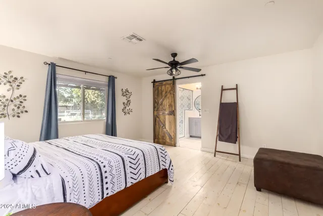 a bedroom with a bed and a view of closet