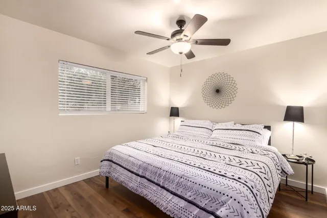 a bedroom with furniture and wooden floor