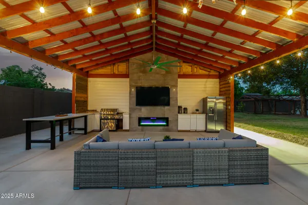 a kitchen with stainless steel appliances granite countertop a stove a kitchen island a dining table and chairs