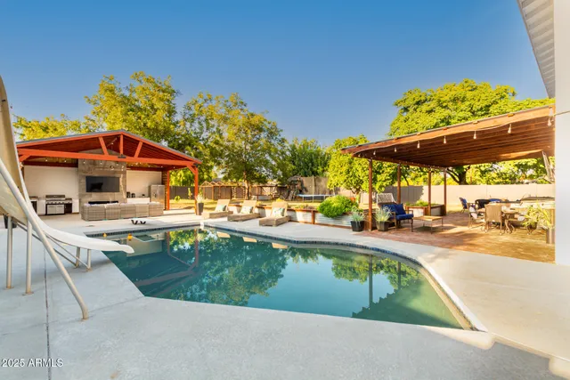 a view of outdoor space with swimming pool and sitting area