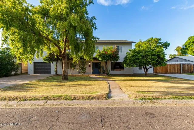 a view of a house with a large tree