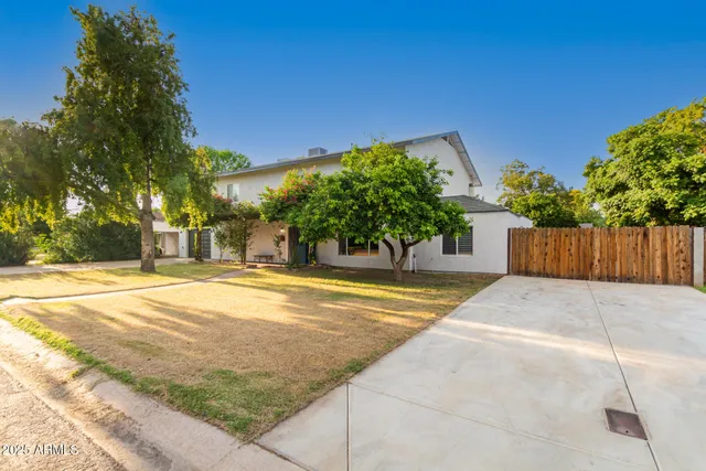 a view of a workspace room with wooden floor and windows