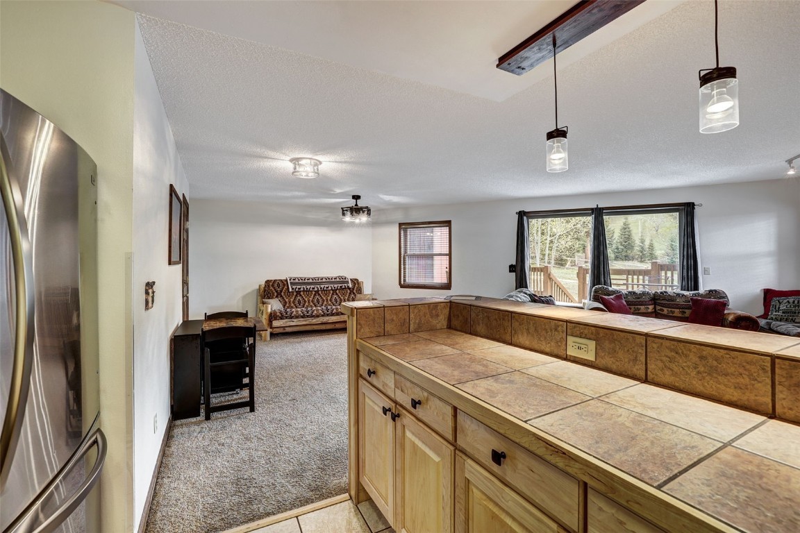 840 4 O Clock Road, Unit A1D Breckenridge, CO 80424 - Photo 11 of 38 a kitchen with granite countertop a stove and a refrigerator