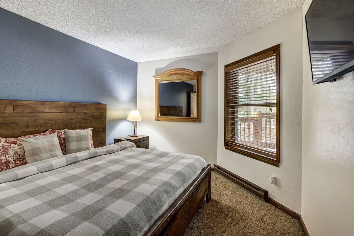 840 4 O Clock Road, Unit A1D Breckenridge, CO 80424 - Photo 19 of 38 a bedroom with a bed and a window