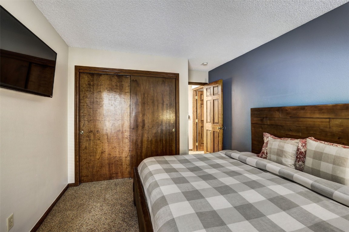 840 4 O Clock Road, Unit A1D Breckenridge, CO 80424 - Photo 20 of 38 a bedroom with a bed and a television