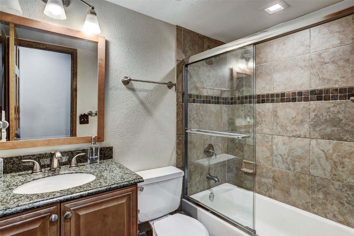 840 4 O Clock Road, Unit A1D Breckenridge, CO 80424 - Photo 21 of 38 a bathroom with a granite countertop sink toilet and shower
