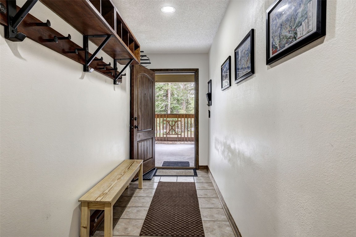 840 4 O Clock Road, Unit A1D Breckenridge, CO 80424 - Photo 22 of 38 a view of a hallway with wooden floor and staircase