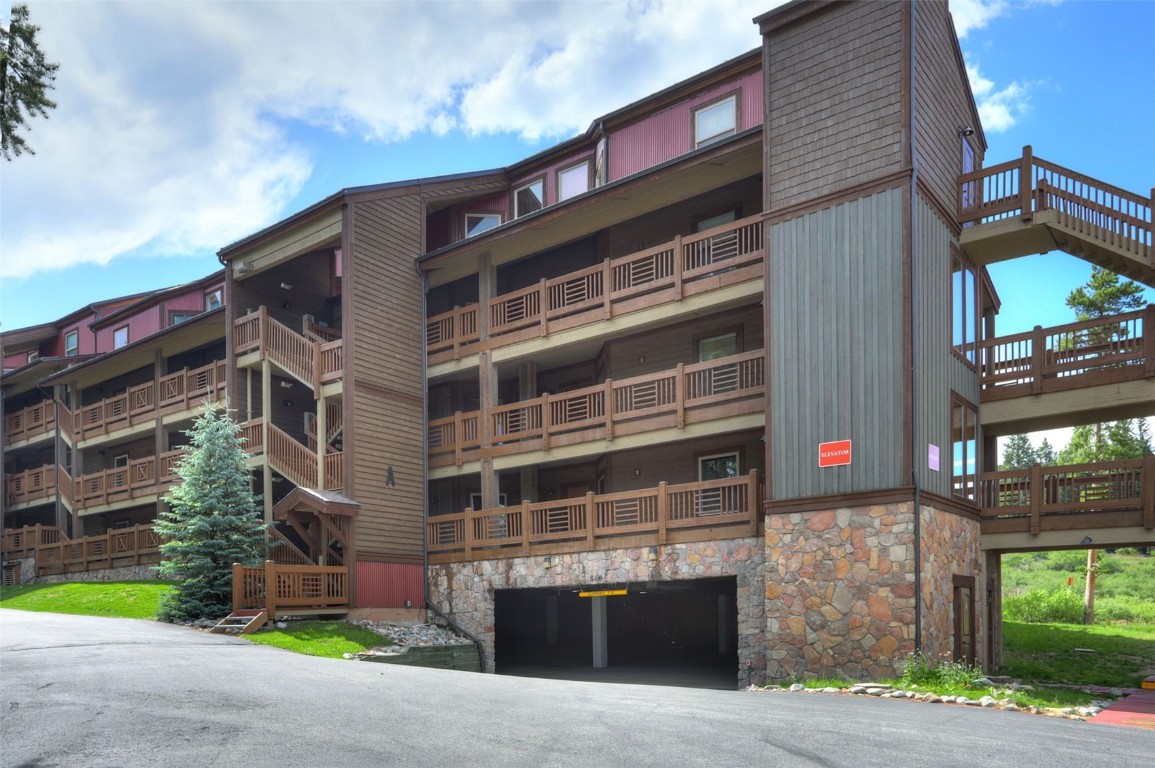 840 4 O Clock Road, Unit A1D Breckenridge, CO 80424 - Photo 32 of 38 a front view of a building with a garden and a garage