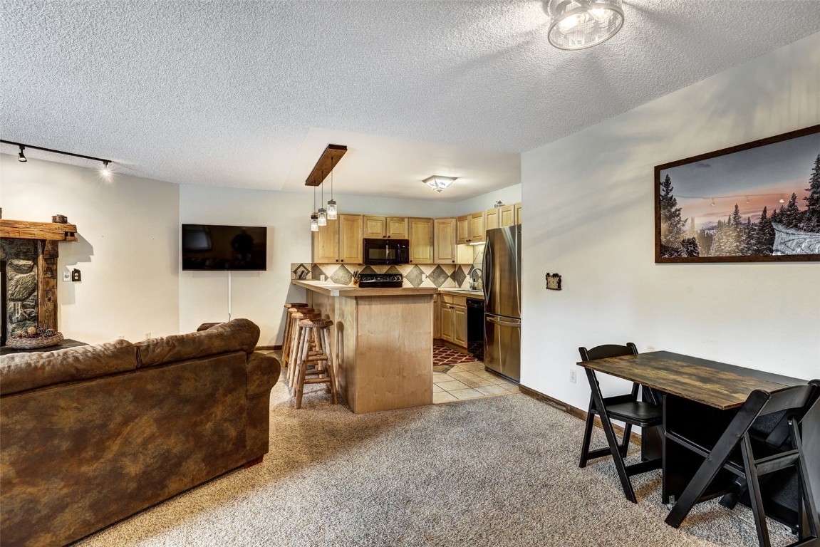 840 4 O Clock Road, Unit A1D Breckenridge, CO 80424 - Photo 8 of 38 a living room with furniture and a flat screen tv