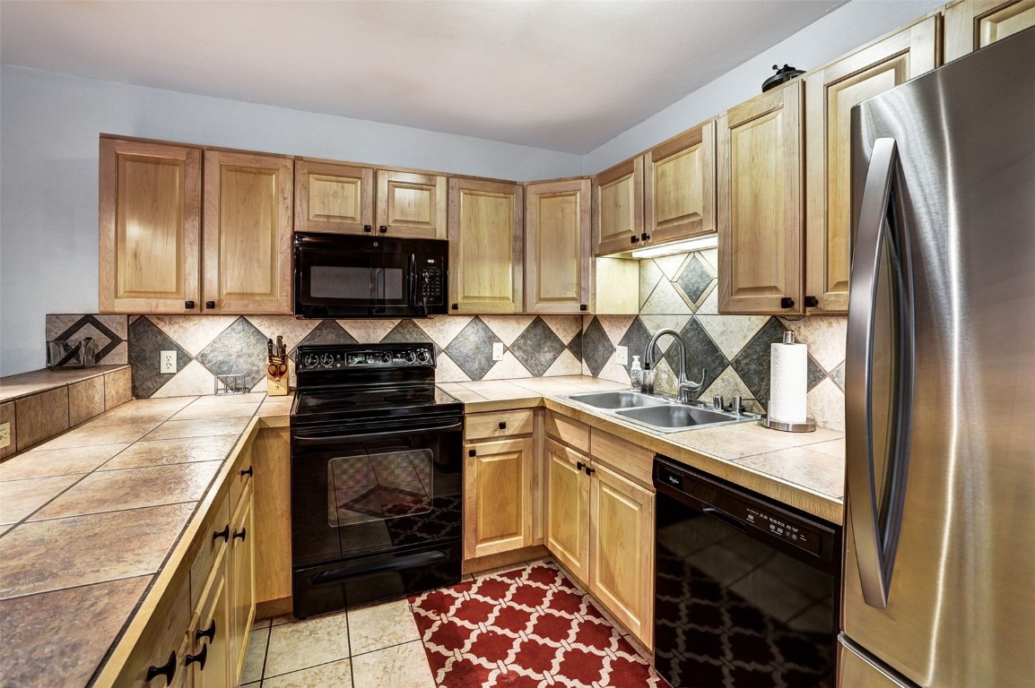 840 4 O Clock Road, Unit A1D Breckenridge, CO 80424 - Photo 10 of 38 a kitchen with a sink stove and refrigerator
