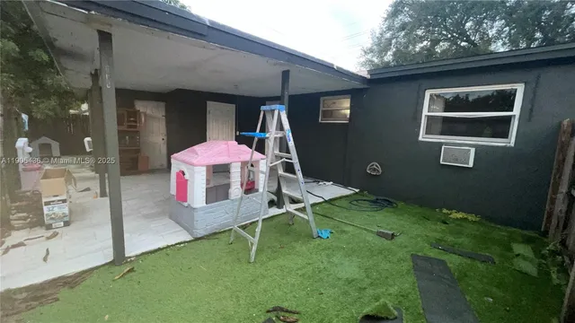 a backyard of a house with table and chairs