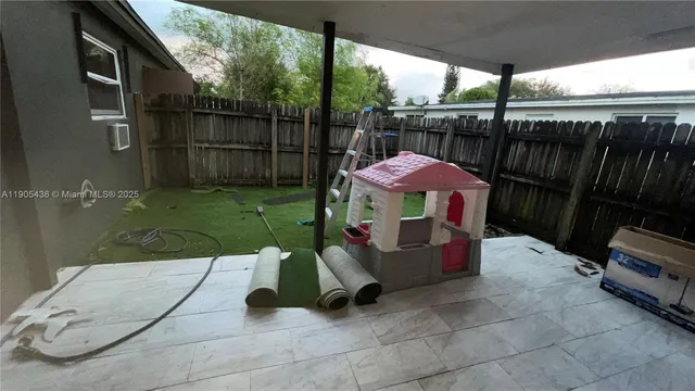 a view of backyard with barbeque grill and outdoor seating