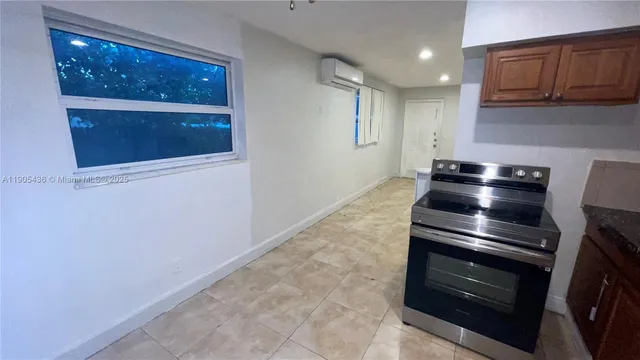 a kitchen with granite countertop a stove and a microwave
