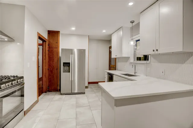 a kitchen with a refrigerator a sink and a stove