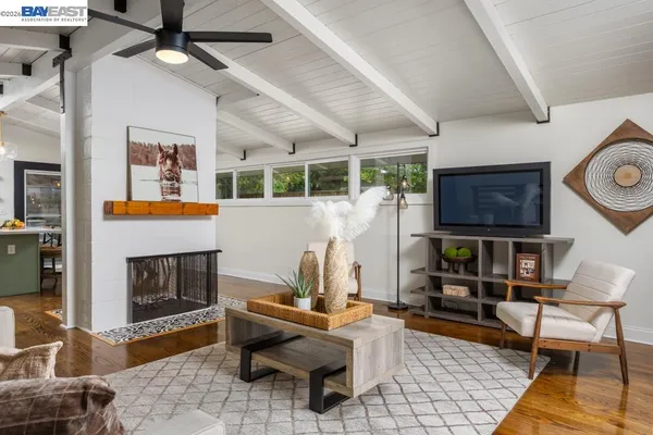 a living room with furniture a fireplace and a table