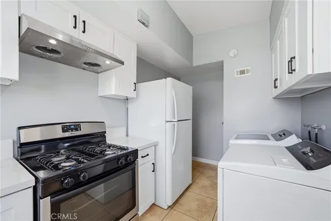a kitchen with a stove and a refrigerator