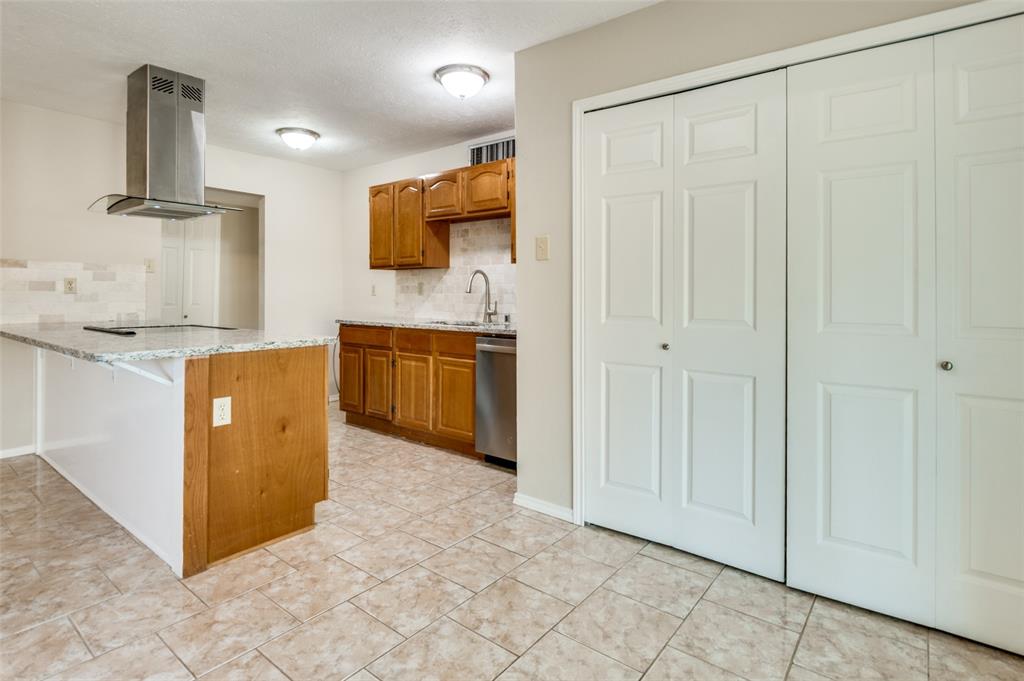 10257 Sweet Gum Street Dallas, TX 75249 - Photo 12 of 29 a view of a kitchen with stainless steel appliances granite countertop a sink and a stove top oven