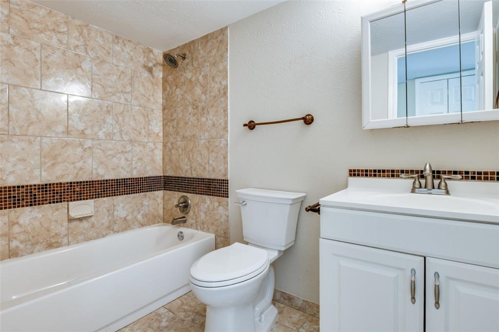 10257 Sweet Gum Street Dallas, TX 75249 - Photo 18 of 29 a bathroom with a sink a toilet and bathtub