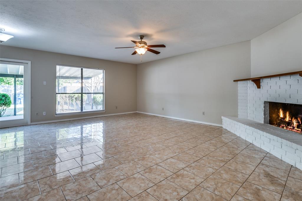 10257 Sweet Gum Street Dallas, TX 75249 - Photo 4 of 29 an empty room with windows and fireplace