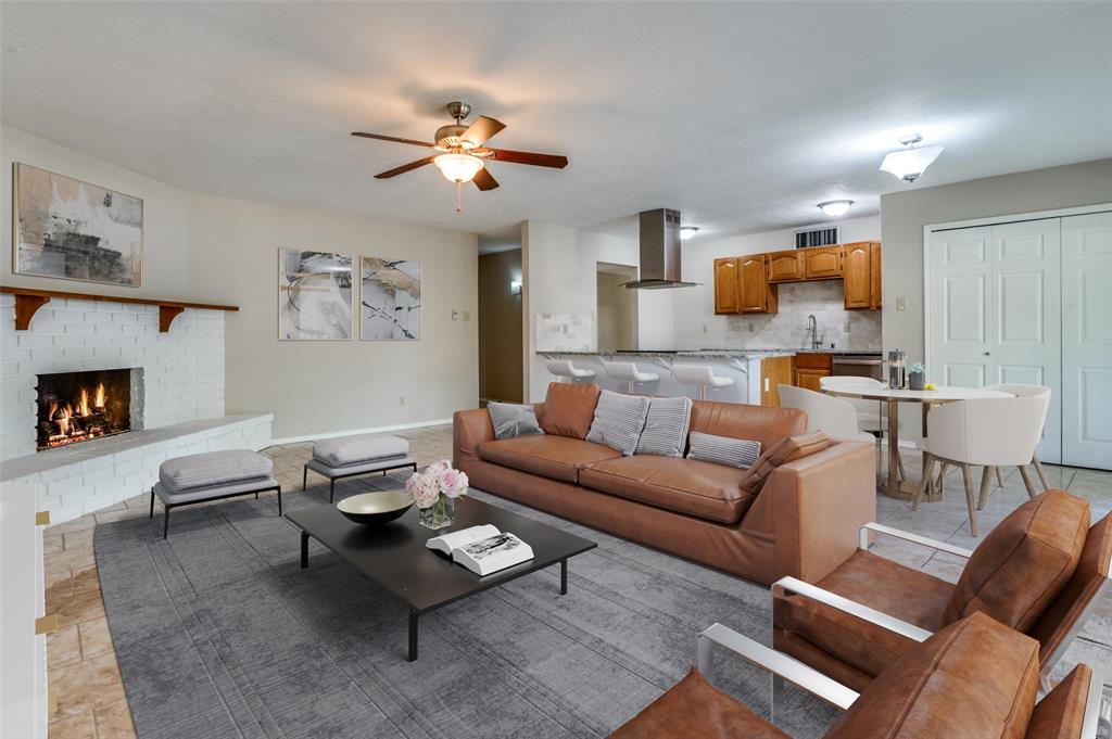 10257 Sweet Gum Street Dallas, TX 75249 - Photo 6 of 29 a living room with furniture and a fireplace