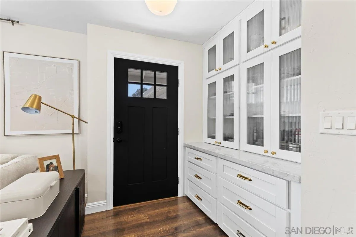 12243 Buckskin Trail Poway, CA 92064 - Photo 4 of 41 a view of an entryway with wooden floor and cabinet